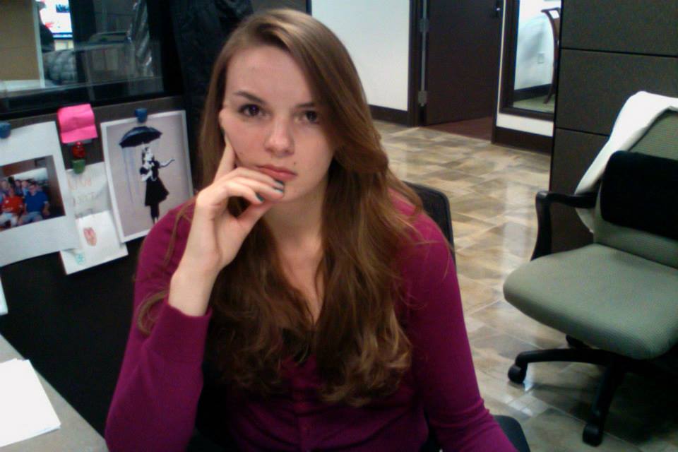 Angela at a desk looking frustrated. 