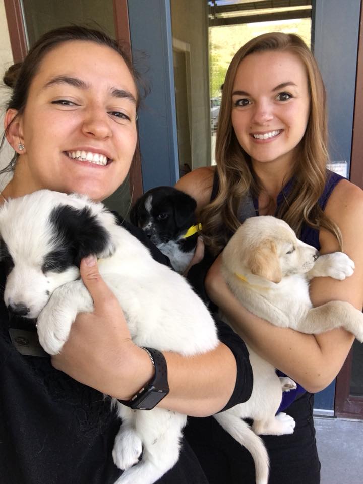 Nayla and Angela holding puppies